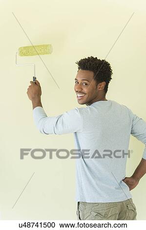 Man painting wall View Large Photo Image Stock Image - Man painting wall. Fotosearch