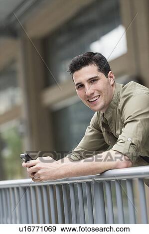 Stock Photo - Man text messaging. Fotosearch