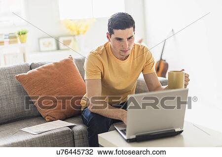 Man using laptop at home View Large Photo Image Stock Image - Man using laptop at home. Fotosearch