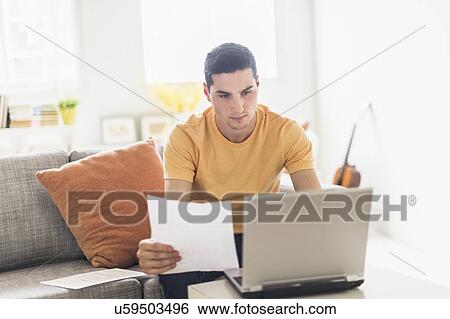 Man using laptop at home View Large Photo Image Stock Photograph - Man using laptop at home. Fotosearch