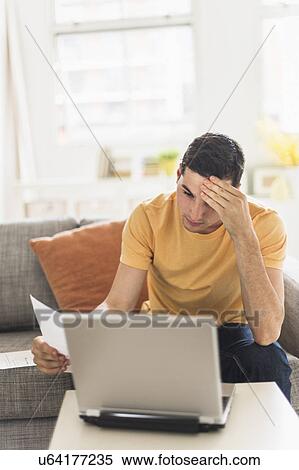 Man using laptop at home View Large Photo Image Stock Photography - Man using laptop at home. Fotosearch