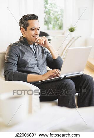 Stock Photo - Man working at home. Fotosearch