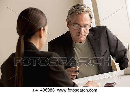 Mature man and woman working together View Large Photo Image Stock Image - Mature man and woman working together. Fotosearch