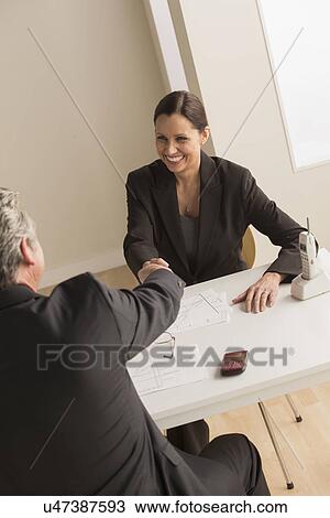 Stock Image - Mature man and woman working together. Fotosearch