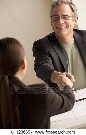 Stock Photo - Mature man and woman working together. Fotosearch