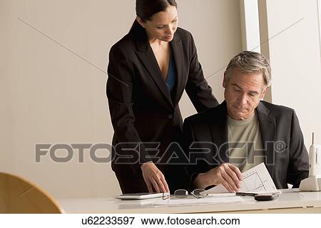 Stock Photo - Mature man and woman working together. Fotosearch