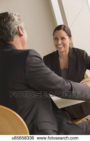 Stock Photograph - Mature man and woman working together. Fotosearch
