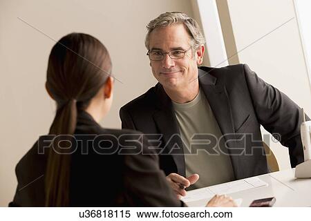 Stock Photography - Mature man and woman working together. Fotosearch