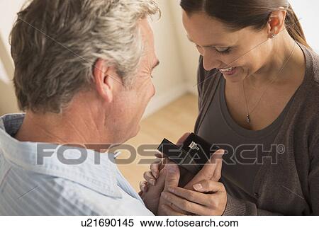 Stock Photography - Mature man proposing to mature woman. Fotosearch