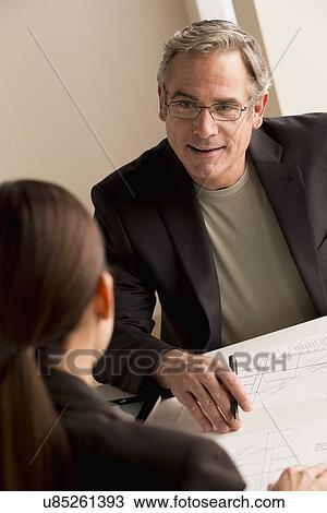 Mature man working with mature woman View Large Photo Image Stock Image - Mature man working with mature woman. Fotosearch