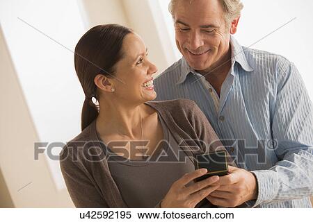 Mature woman holding gift from mature woman View Large Photo Image Stock Photography - Mature woman holding gift from mature woman. Fotosearch