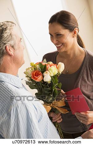 Mature woman receiving bouquet from mature man View Large Photo Image Stock Image - Mature woman receiving bouquet from mature man. Fotosearch