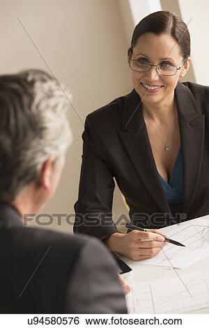 Mature woman working with mature man View Large Photo Image Stock Photograph - Mature woman working with mature man. Fotosearch