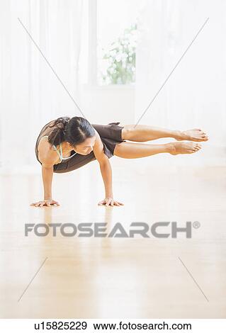 Mid adult woman practicing yoga View Large Photo Image Stock Photo - Mid adult woman practicing yoga. Fotosearch