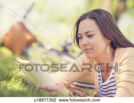 Mid adult woman reading book View Large Photo Image Stock Image - Mid adult woman reading book. Fotosearch