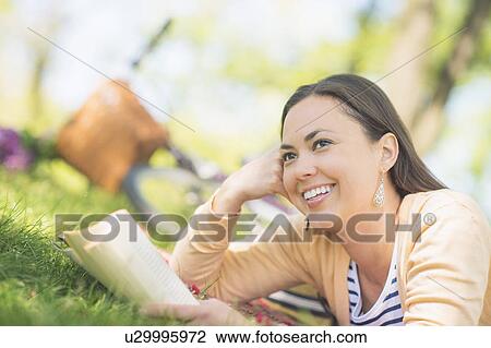 Mid adult woman reading book View Large Photo Image Stock Image - Mid adult woman reading book. Fotosearch