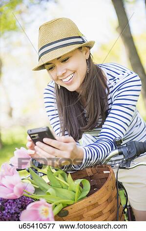 Mid adult woman using mobile phone View Large Photo Image Stock Photo - Mid adult woman using mobile phone. Fotosearch