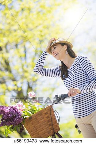 Mid adult woman with bicycle View Large Photo Image Stock Image - Mid adult woman with bicycle. Fotosearch