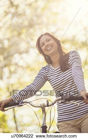 Mid adult woman with bicycle View Large Photo Image Stock Image - Mid adult woman with bicycle. Fotosearch