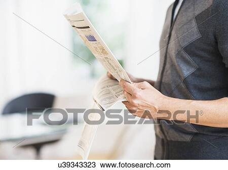 Mid section of man holding newspaper View Large Photo Image Stock Image - Mid section of man holding newspaper . Fotosearch