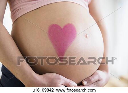 Mid section of pregnant woman with drawing of heart on belly View Large Photo Image Stock Image - Mid section of pregnant woman with drawing of heart on belly. Fotosearch