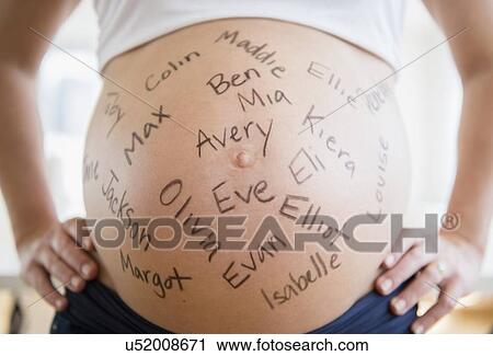 Mid section of pregnant woman with names written on her belly View Large Photo Image Stock Image - Mid section of pregnant woman with names written on her belly. Fotosearch
