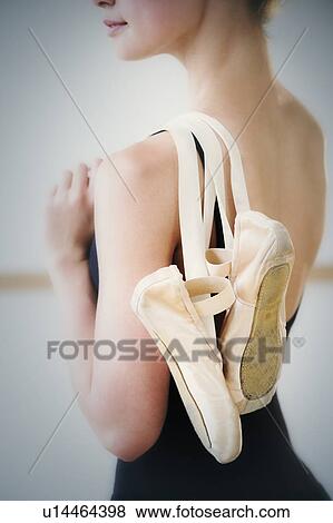 Mid section of teenage (16-17) ballet dancer holding ballet shoes View Large Photo Image Stock Photo - Mid section of teenage (16-17) ballet dancer holding ballet shoes. Fotosearch