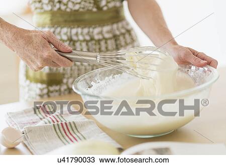 Midsection of woman whisking batter View Large Photo Image Stock Image - Midsection of woman whisking batter. Fotosearch