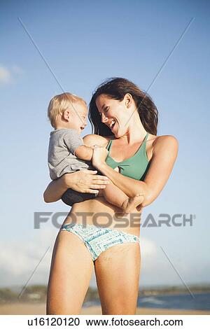 Mother with baby boy (6-11) in arms View Large Photo Image Stock Image - Mother with baby boy (6-11) in arms. Fotosearch