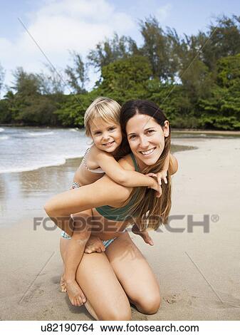 Picture - Mother with daughter (2-3) on beach. Fotosearch