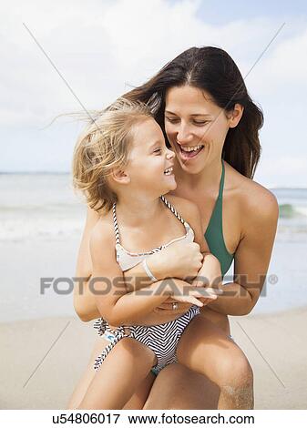 Stock Photo - Mother with daughter (2-3) on beach. Fotosearch
