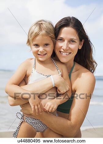 Stock Photography - Mother with daughter (2-3) on beach. Fotosearch