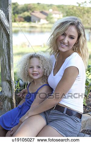 Mother with daughter (4-5) sitting outdoors View Large Photo Image Stock Photo - Mother with daughter (4-5) sitting outdoors. Fotosearch