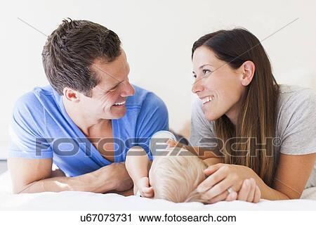 Stock Image - Parents with baby boy (6-11 months). Fotosearch