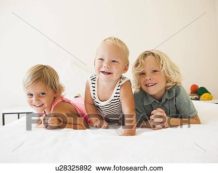 Portrait of boy (6-7), girl (2-3) and their baby brother (6-11 months) View Large Photo Image Stock Image - Portrait of boy (6-7), girl (2-3) and their baby brother (6-11 months). Fotosearch