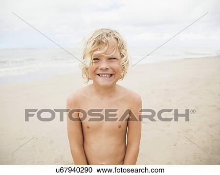 Portrait of boy (6-7) on beach View Large Photo Image Stock Image - Portrait of boy (6-7) on beach. Fotosearch