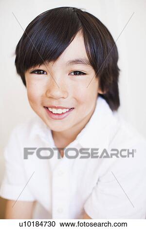 Portrait of boy (8-9) in white shirt View Large Photo Image Stock Image - Portrait of boy (8-9) in white shirt. Fotosearch