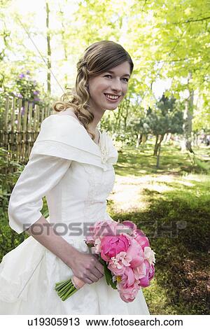 Portrait of bride with bouquet of pink flowers View Large Photo Image Stock Image - Portrait of bride with bouquet of pink flowers. Fotosearch
