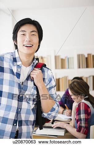 Portrait of cheerful student in library View Large Photo Image Stock Image - Portrait of cheerful student in library. Fotosearch
