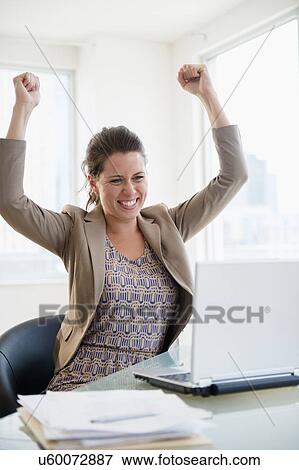 Stock Photo - Portrait of cheering woman in office . Fotosearch