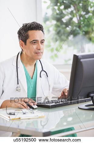 Stock Image - Portrait of doctor working in office. Fotosearch