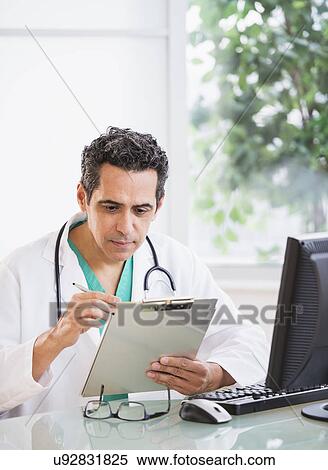Portrait of doctor working in office View Large Photo Image Stock Photography - Portrait of doctor working in office. Fotosearch