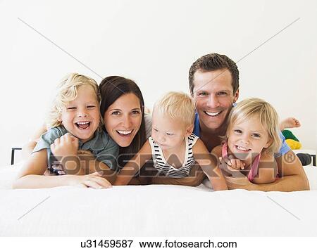 Portrait of family with three kids (6-7, 2-3, 6-11 months) View Large Photo Image Stock Photo - Portrait of family with three kids (6-7, 2-3, 6-11 months). Fotosearch
