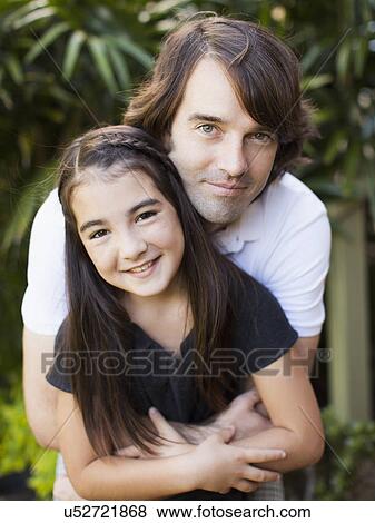 Portrait of father hugging daughter (8-9) View Large Photo Image Stock Photo - Portrait of father hugging daughter (8-9). Fotosearch