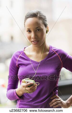 Portrait of female jogger with mp3 player View Large Photo Image Stock Photograph - Portrait of female jogger with mp3 player. Fotosearch