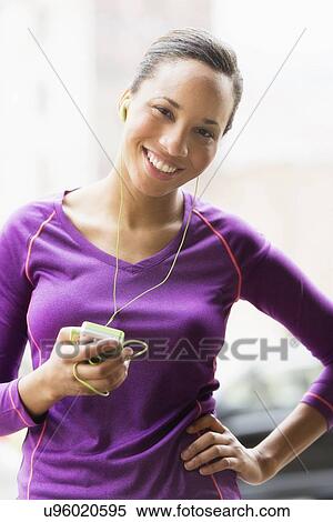 Stock Photography - Portrait of female jogger with mp3 player. Fotosearch