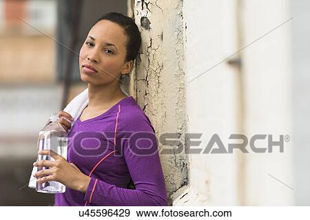 Portrait of female jogger with water bottle View Large Photo Image Stock Photo - Portrait of female jogger with water bottle. Fotosearch
