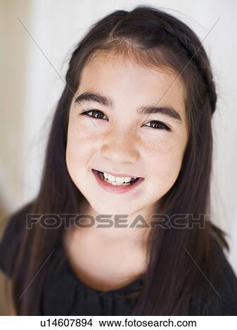 Picture - Portrait of girl (8-9) laying on bed. Fotosearch
