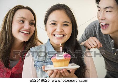 Portrait of happy man and women, one holding cup cake View Large Photo Image Stock Photography - Portrait of happy man and women, one holding cup cake. Fotosearch