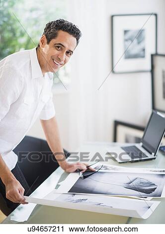 Stock Image - Portrait of man in his photography studio. Fotosearch